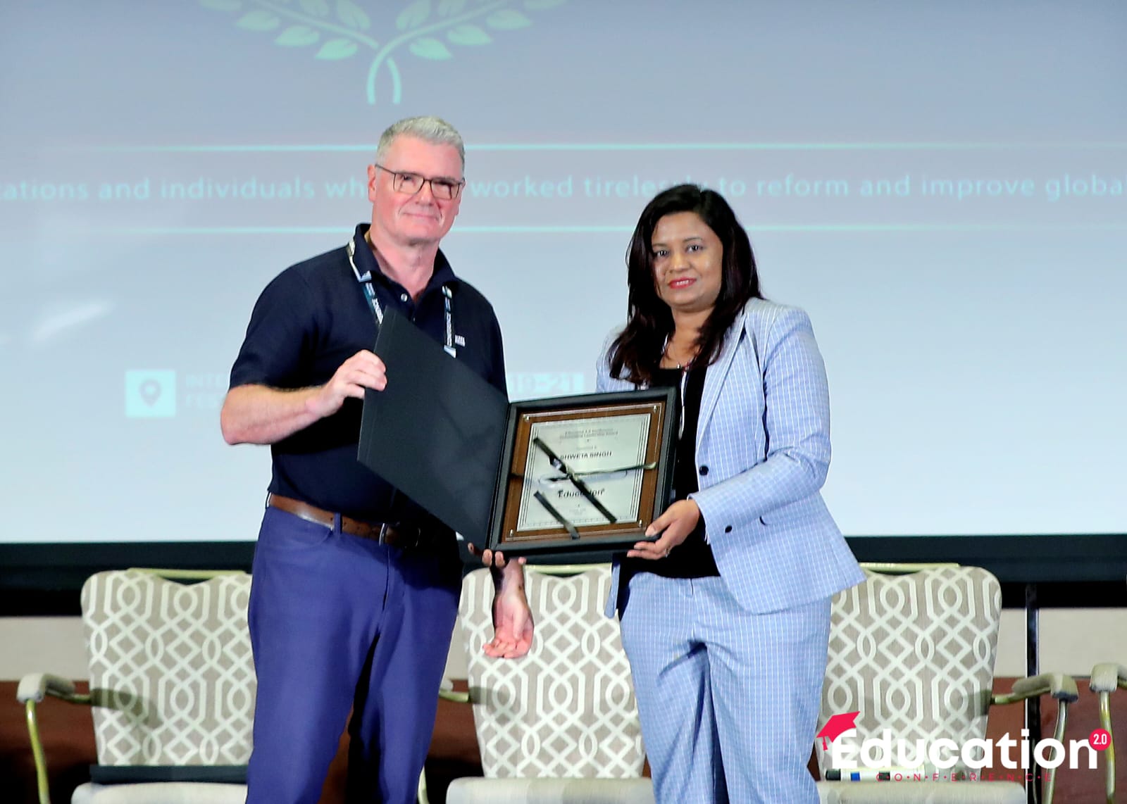 Shwetaa Singh receiving the Outstanding Leadership Award on stage in Dubai